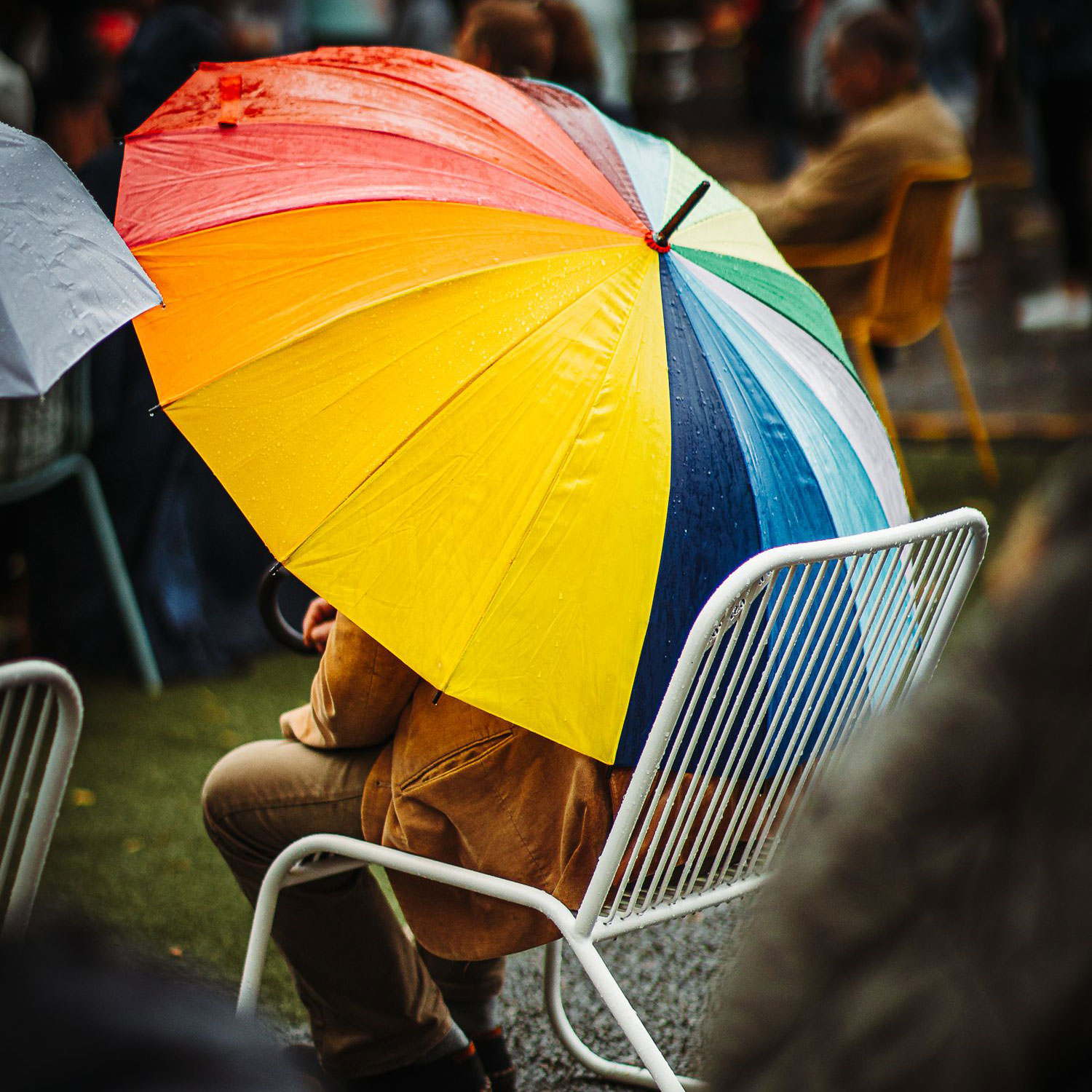 Person sitting under a colourful umbrella during a public event in Tartu. Photo: Peeter Paaver.